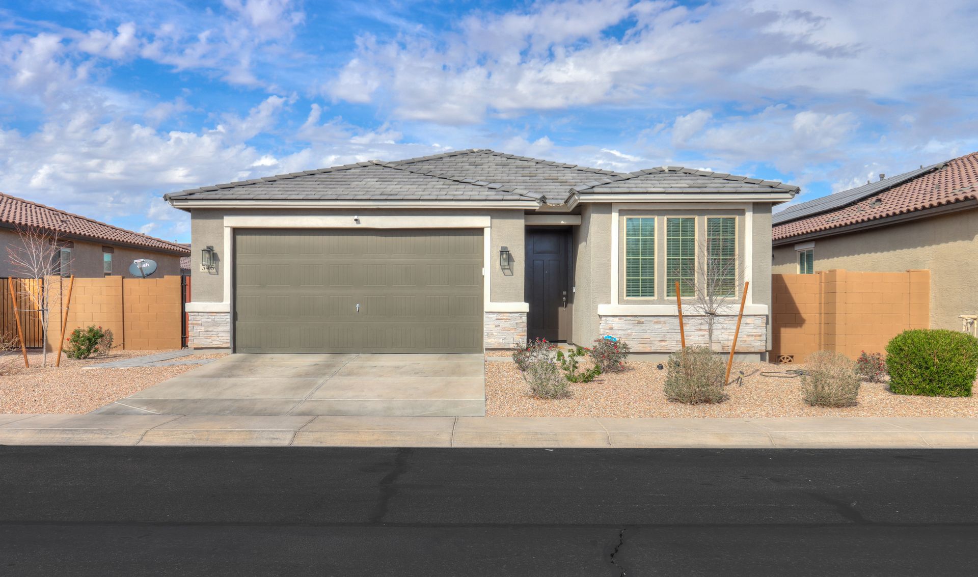 The front of a house with a garage and a driveway.