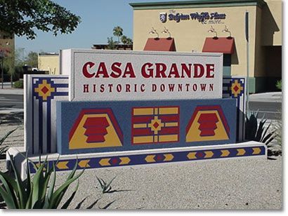 A sign for casa grande historic downtown sits in front of a building
