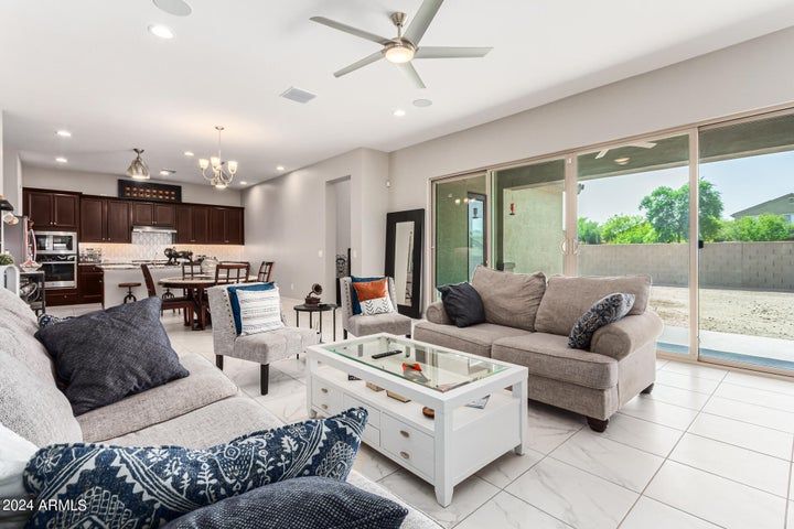 A living room filled with furniture and a ceiling fan.