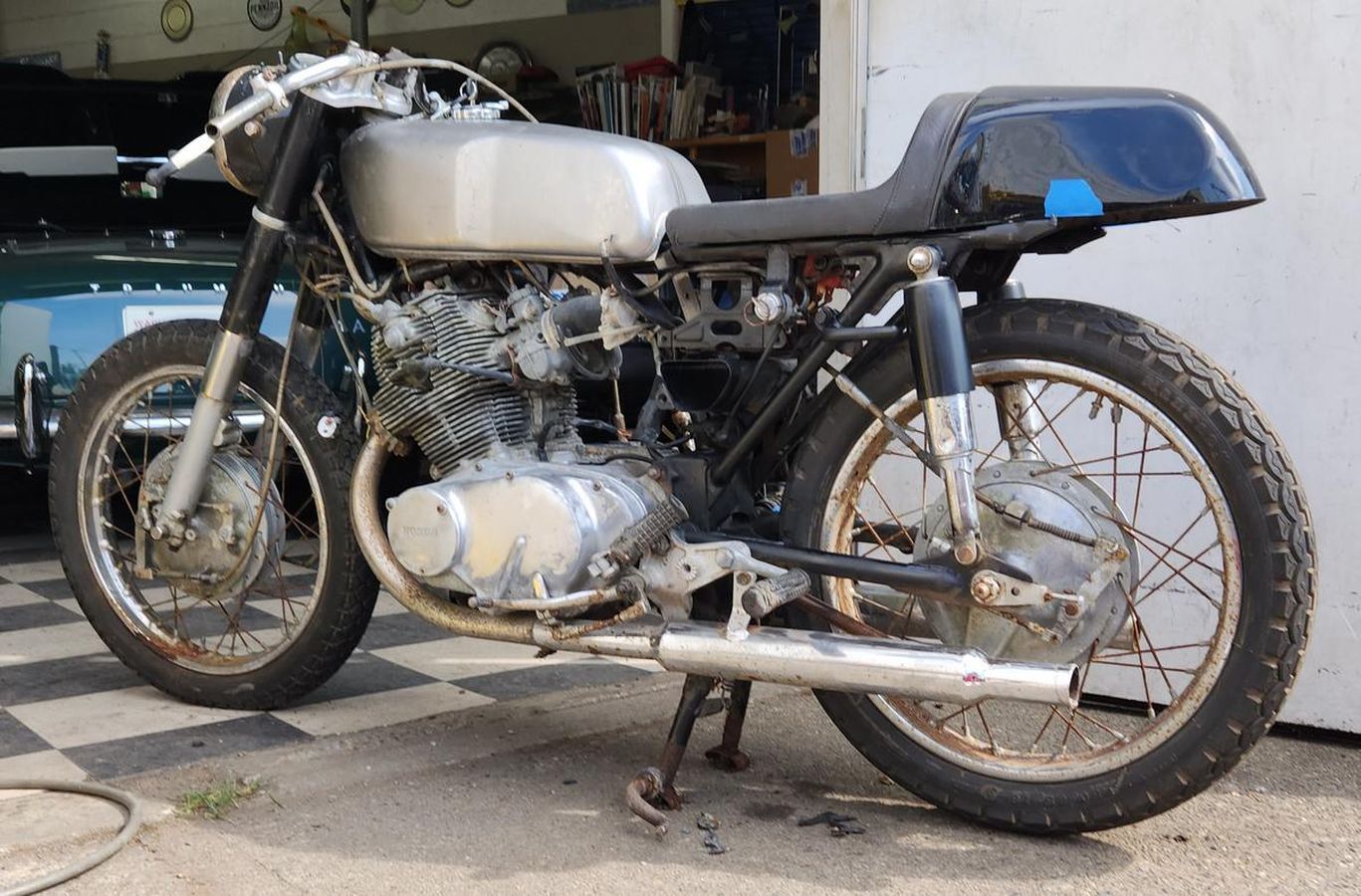 A motorcycle is parked in front of a garage door