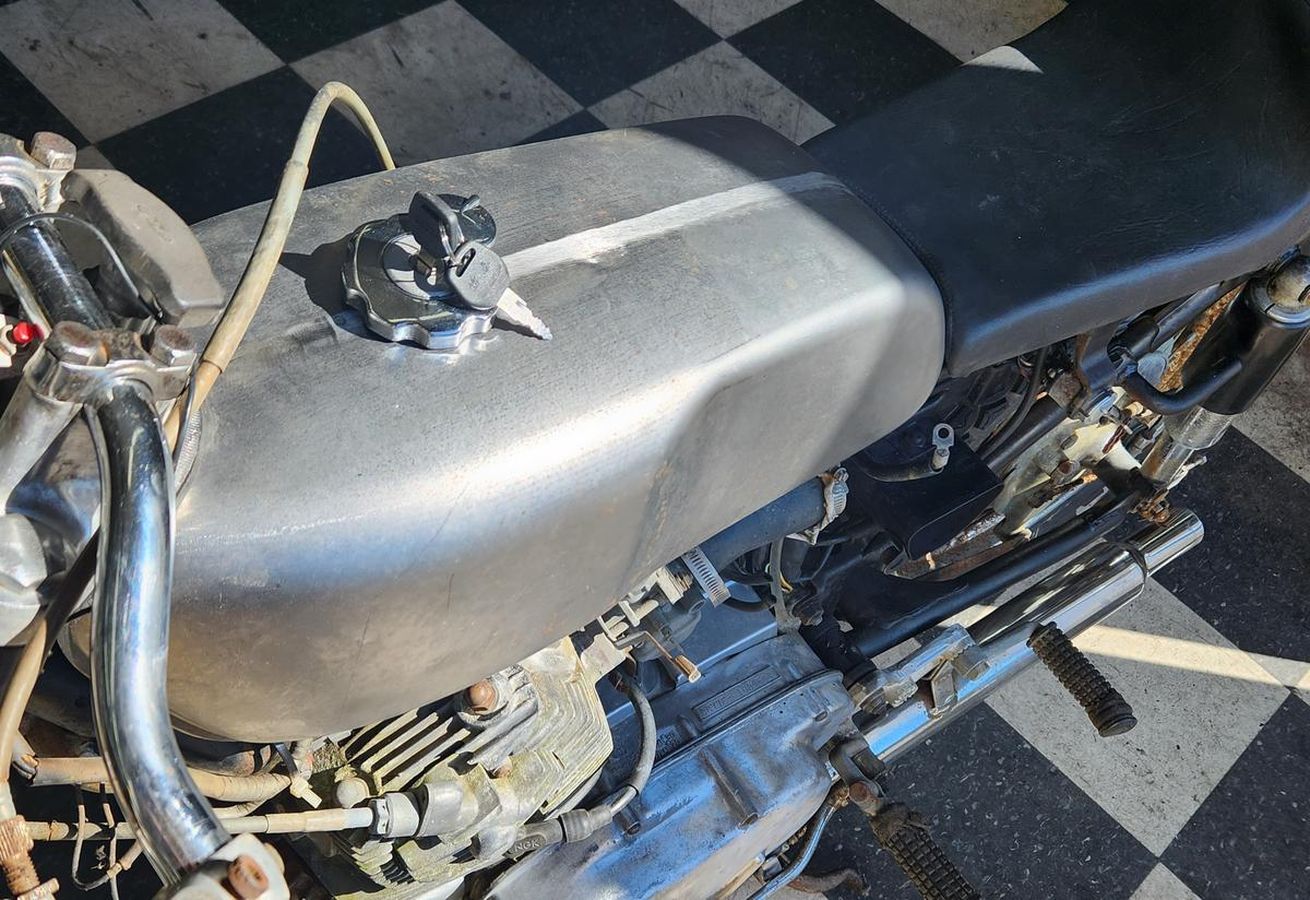 A motorcycle is parked on a checkered floor