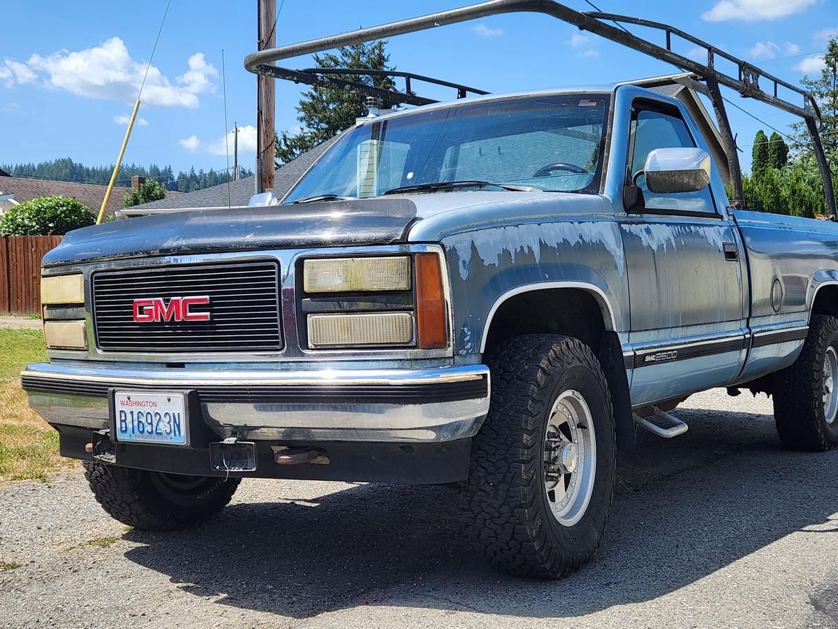 A gmc truck is parked on the side of the road