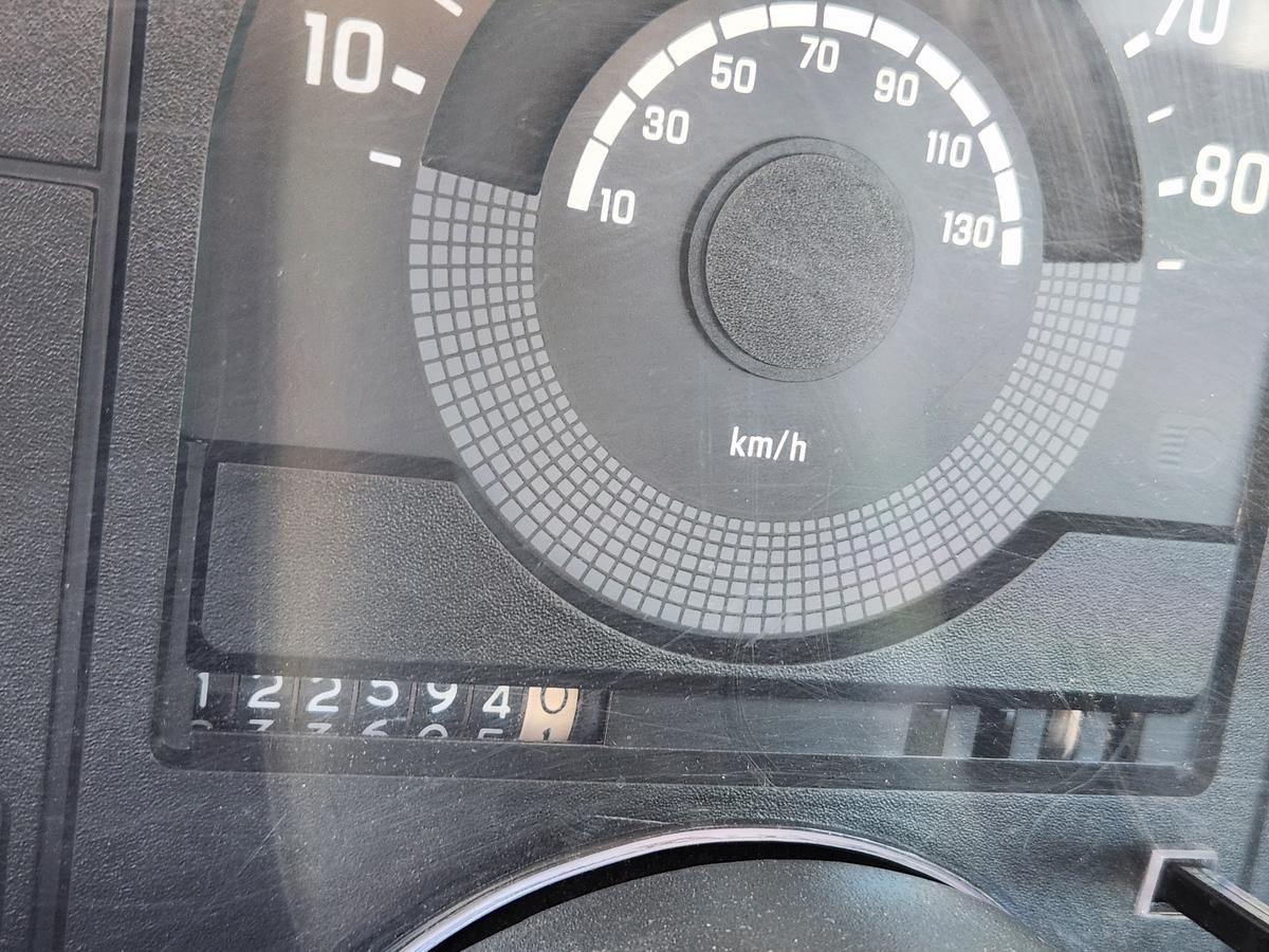 A close up of a speedometer on a car.