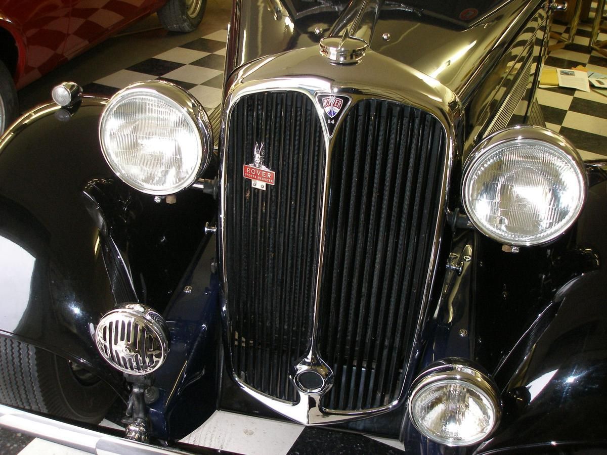 A close up of a black car with a checkered floor