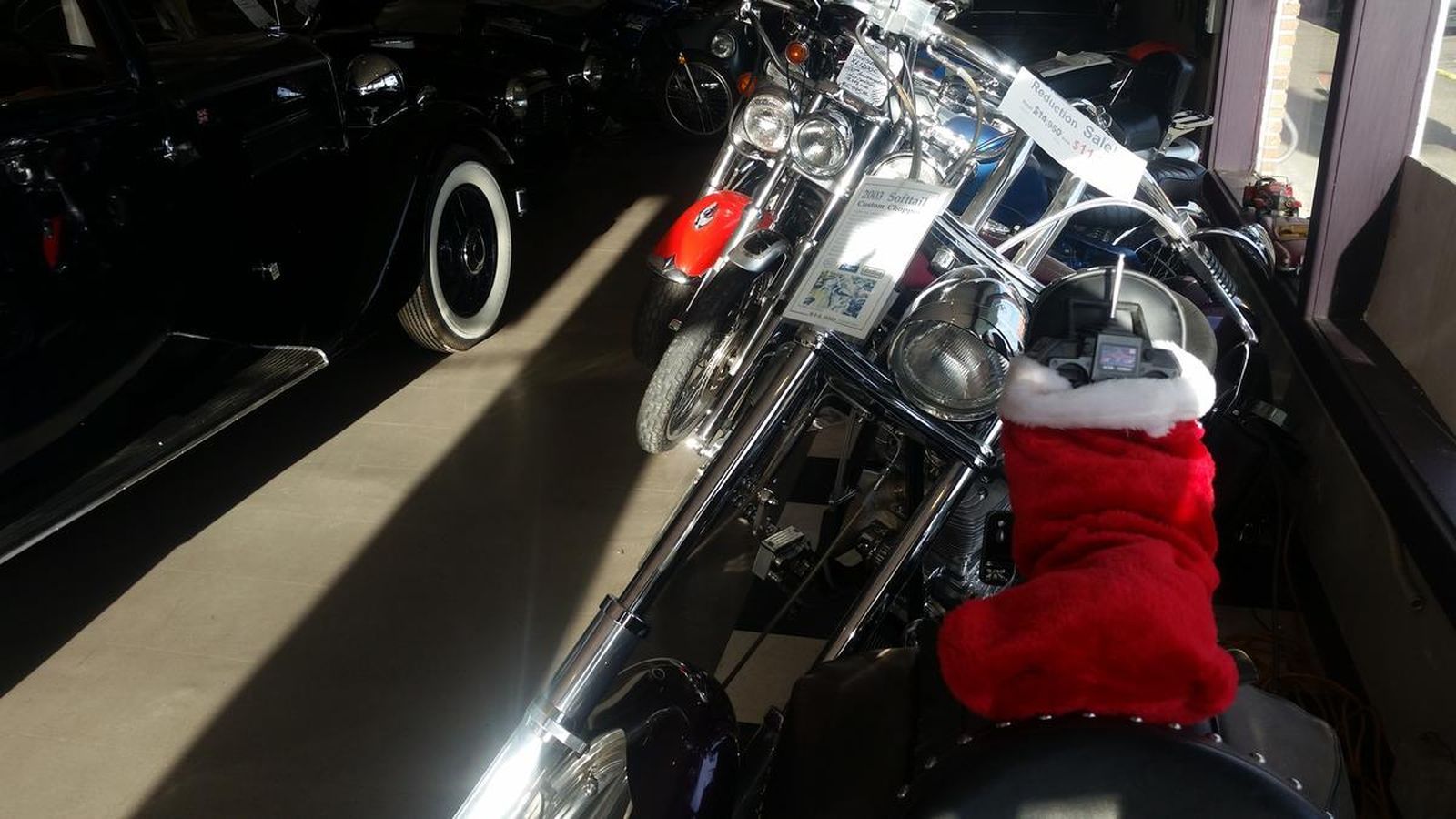 A motorcycle with a santa hat on the handlebars