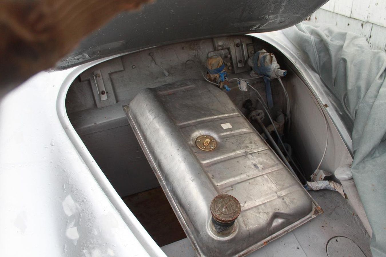 A close up of a fuel tank in the back of a car