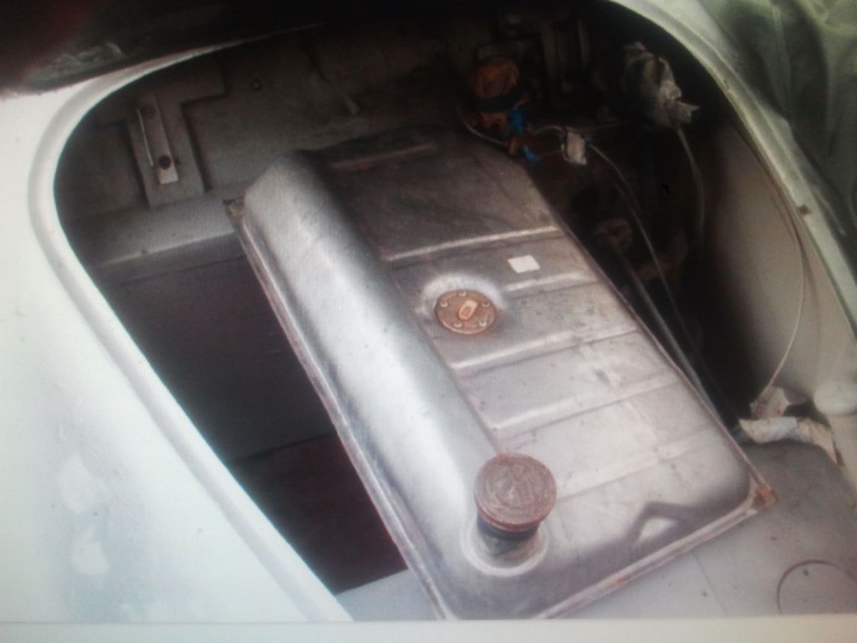 A fuel tank is sitting in the trunk of a car