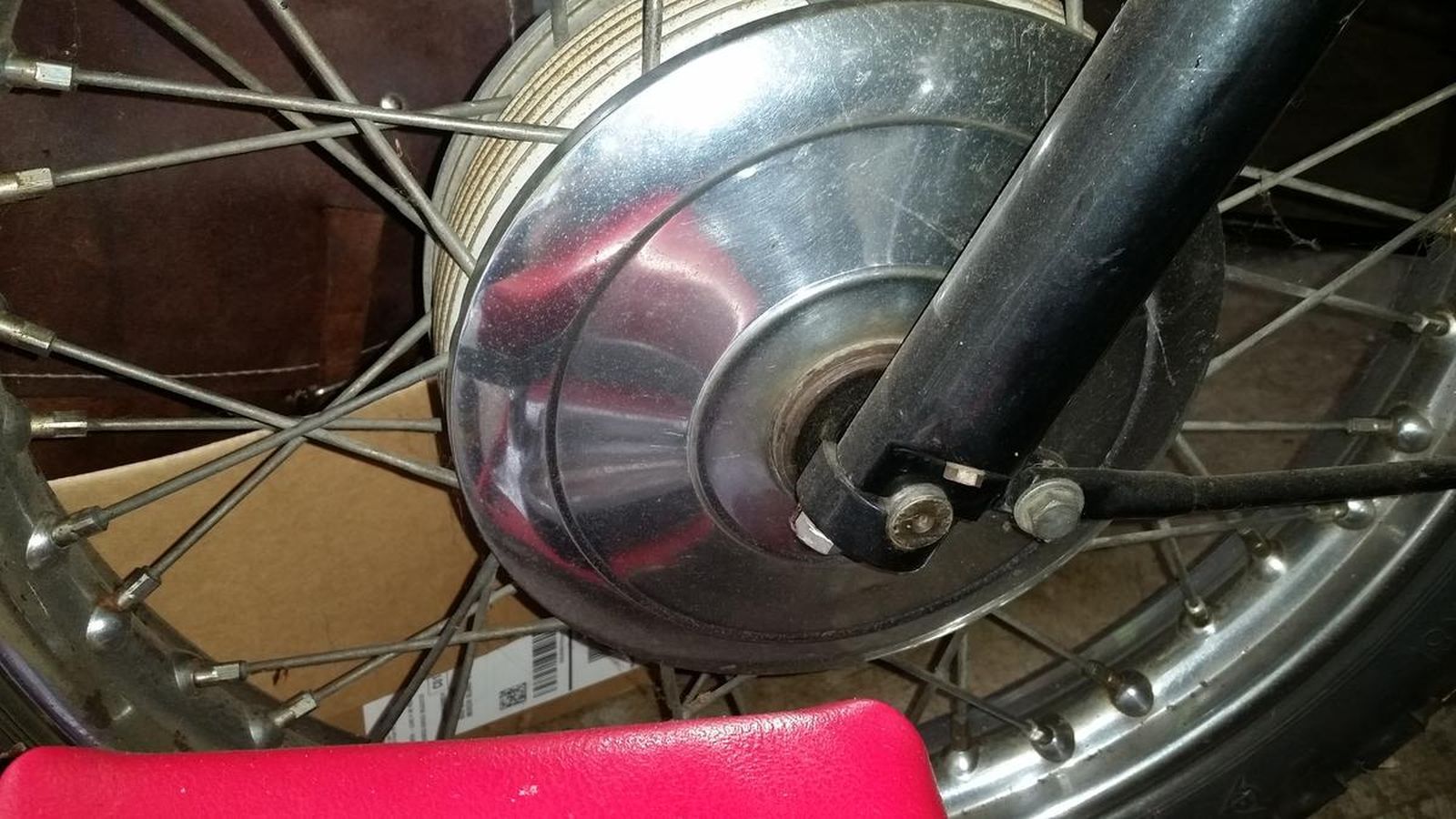 A close up of the front wheel of a motorcycle.