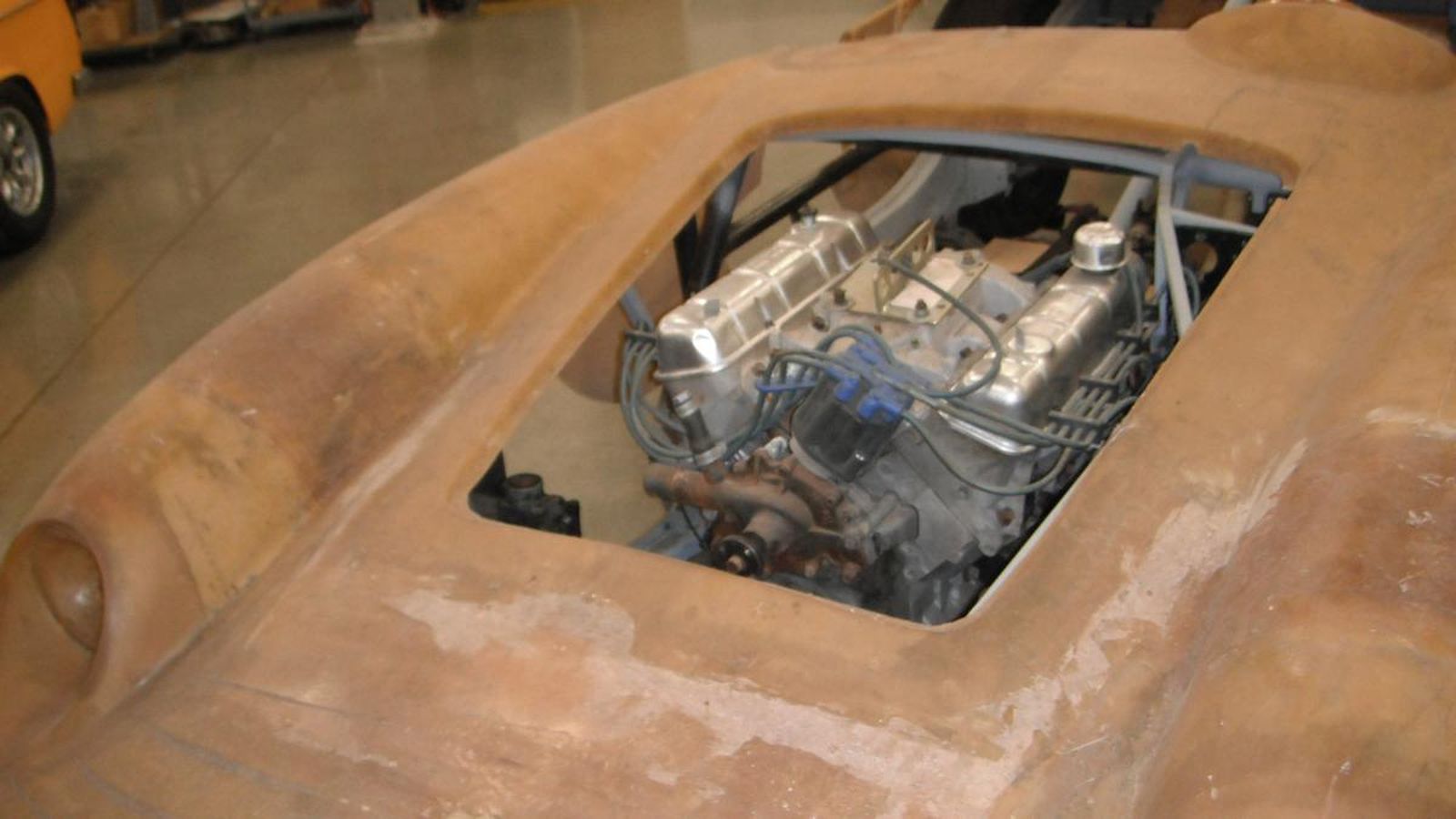 A close up of a car engine with the hood open