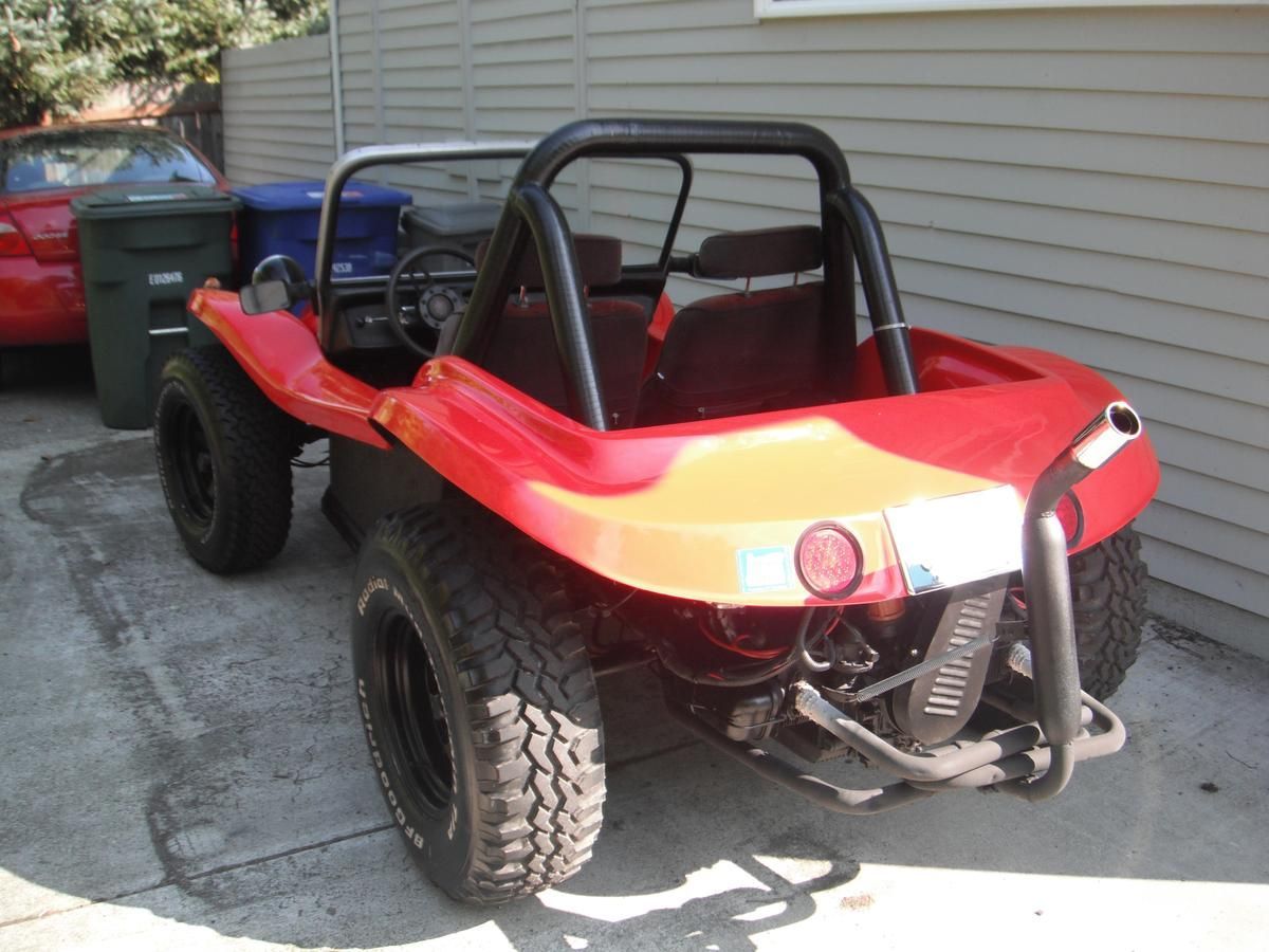 A red buggy is parked in front of a house