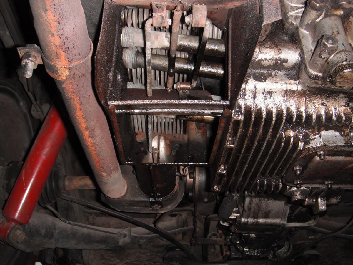 A close up of the underside of a car engine