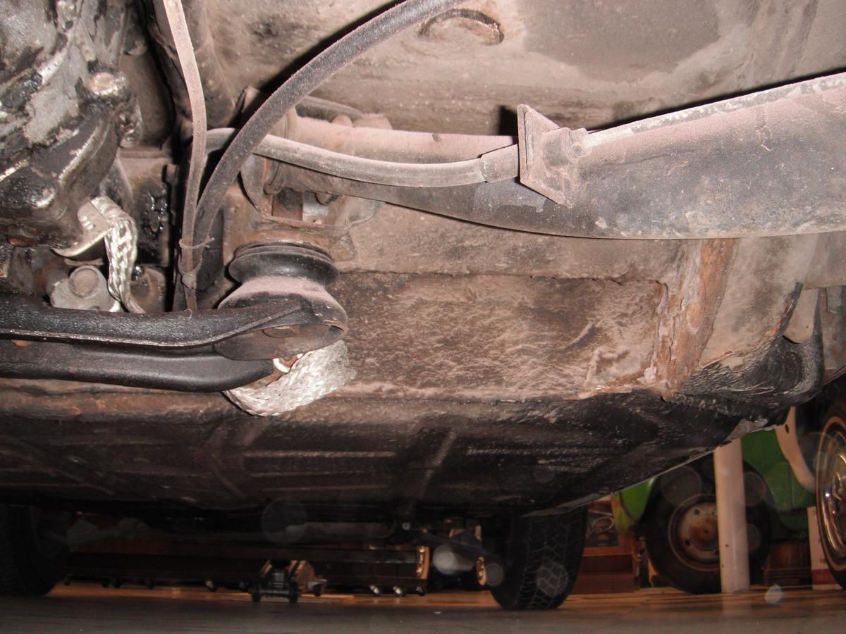 A close up of the underside of a car in a garage