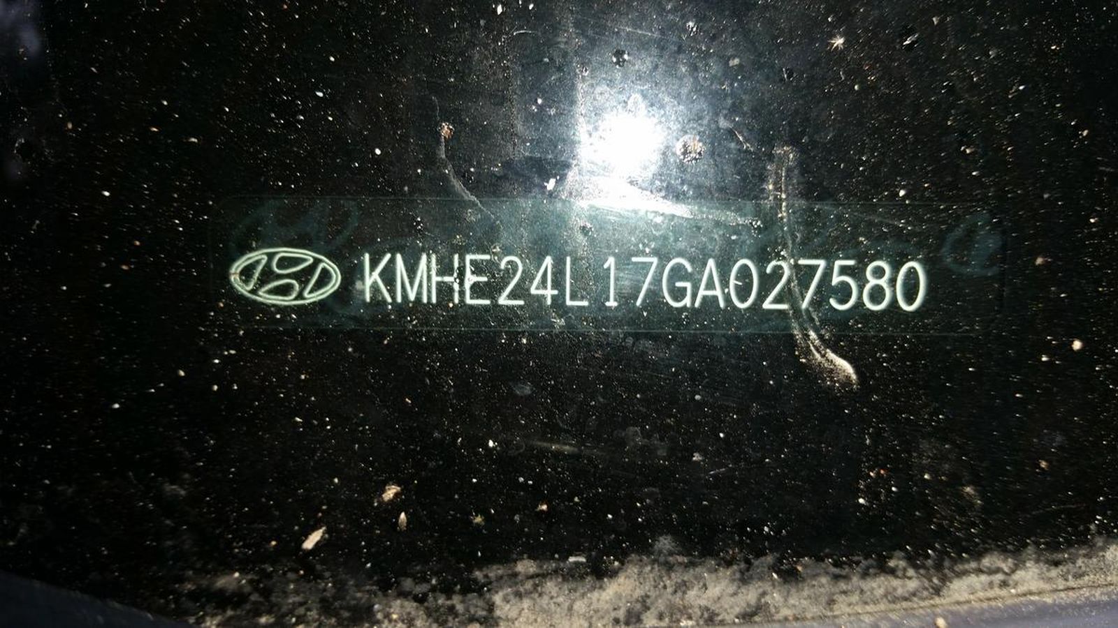 A close up of a license plate on a car window.