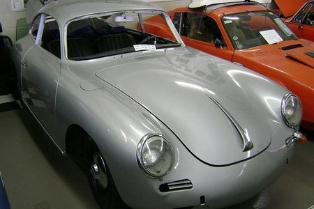 a silver car is parked next to a red car