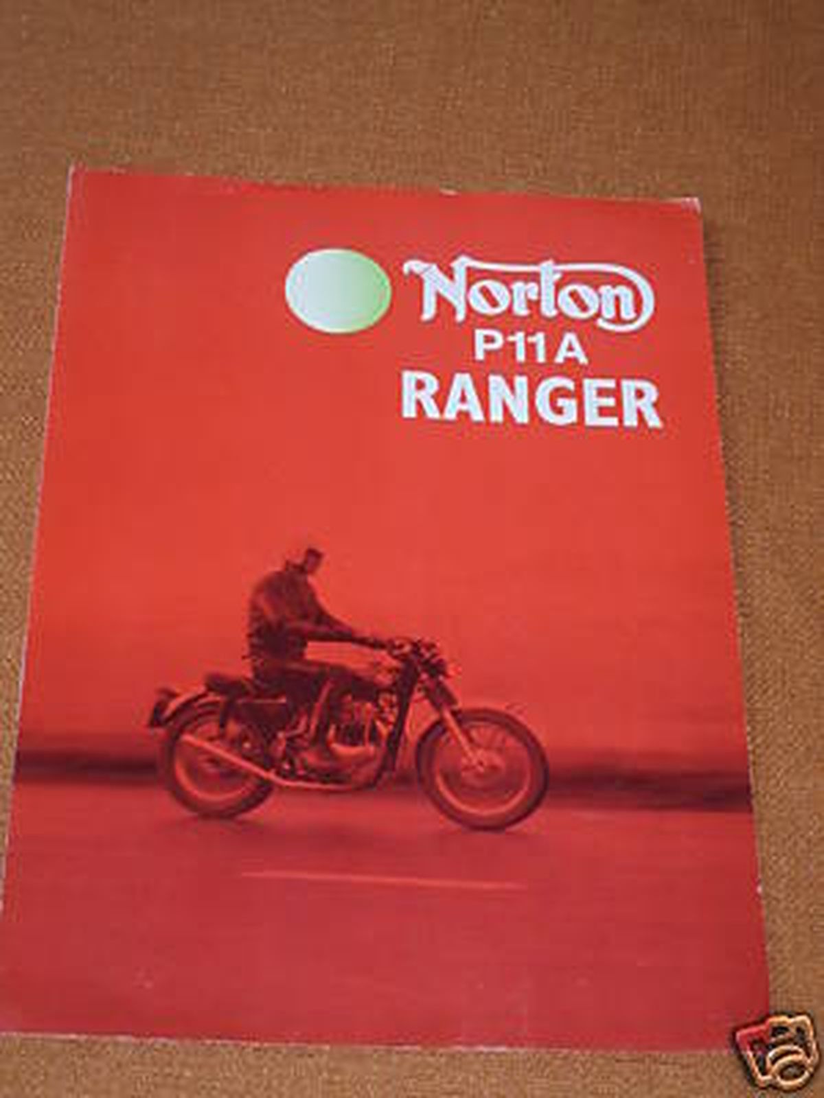 A norton p11a ranger brochure shows a man riding a motorcycle