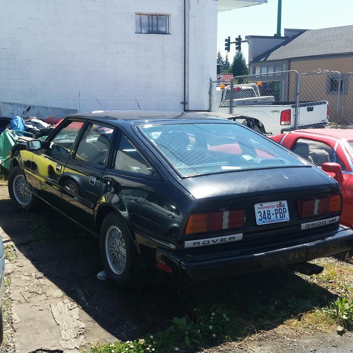 A black car with a license plate that says 340-20