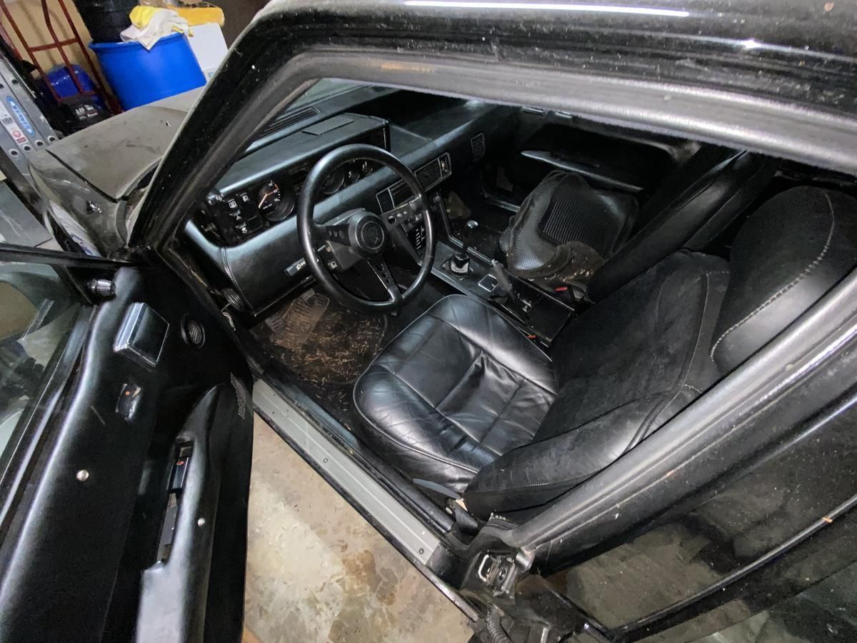 The interior of a black car with the door open