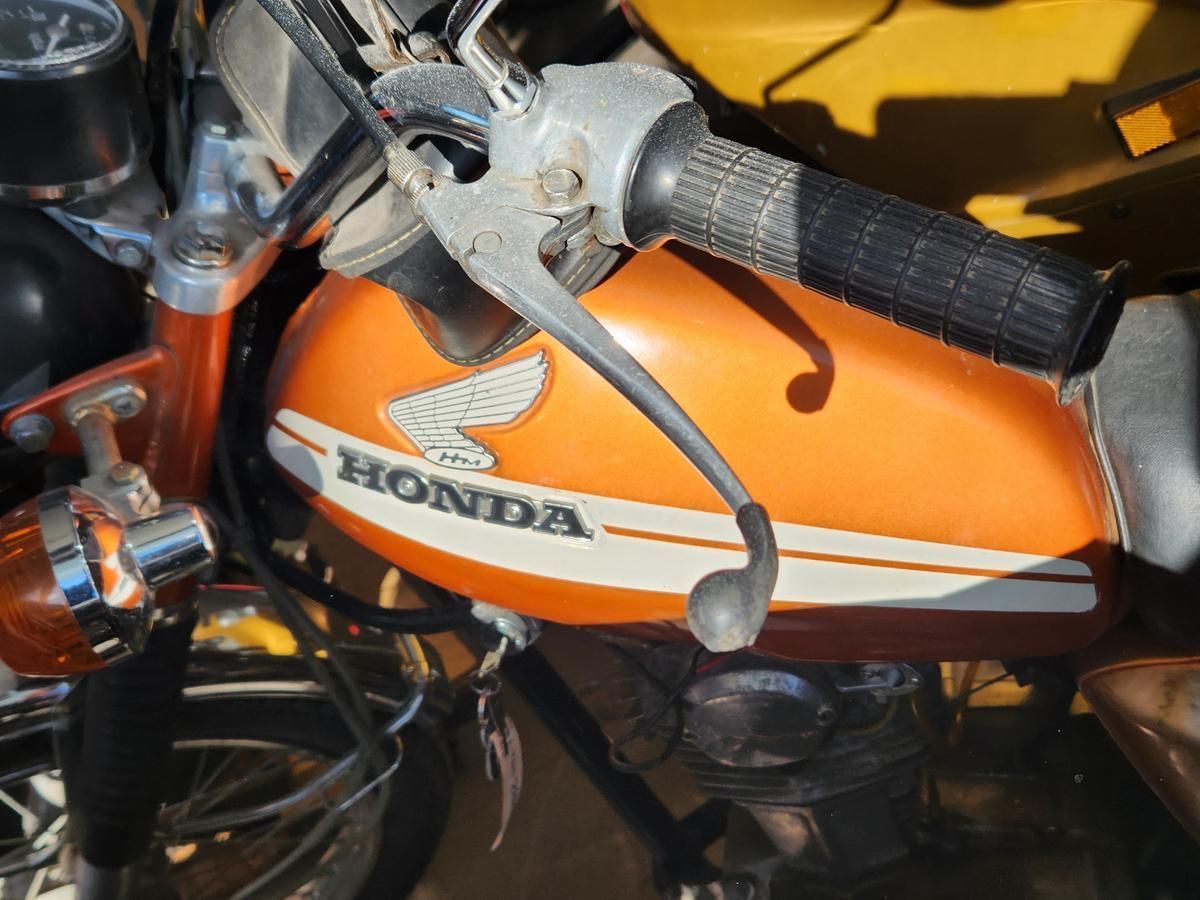 A close up of a honda motorcycle with a brake lever