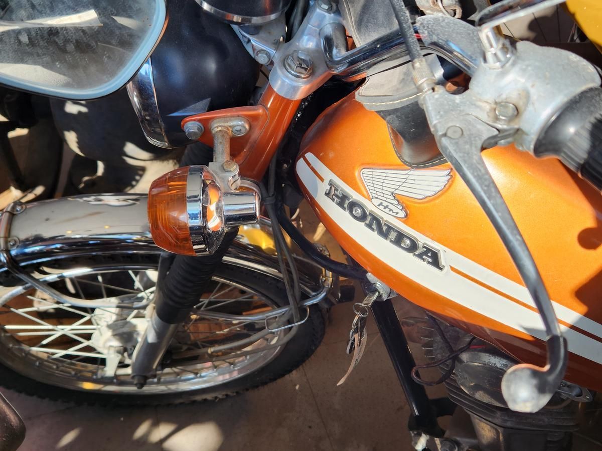 A honda motorcycle is parked next to another motorcycle