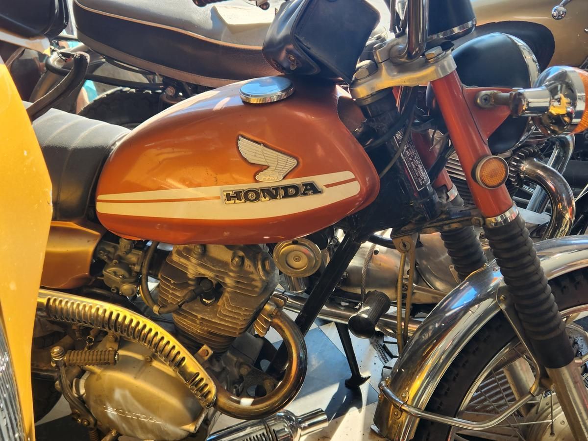 A honda motorcycle is parked next to another motorcycle.