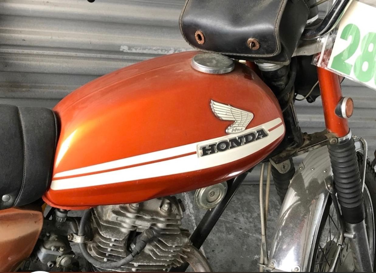 A honda motorcycle is parked in front of a garage door