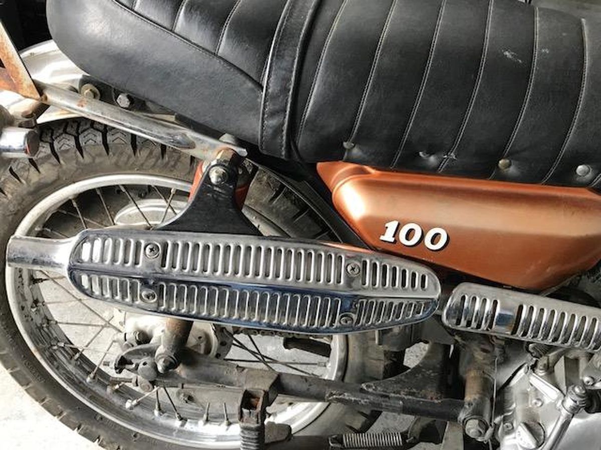 A close up of a motorcycle with the number 100 on the side.