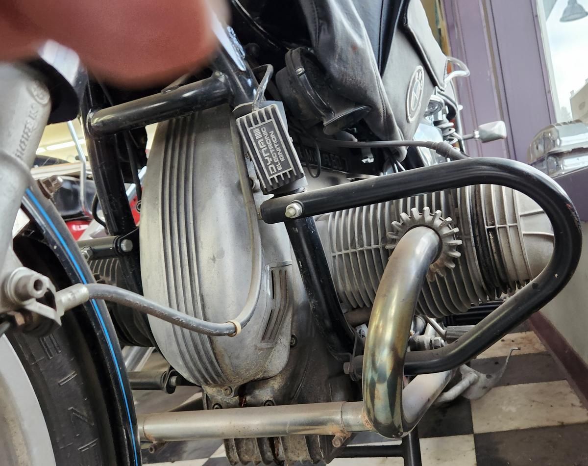 A close up of a motorcycle engine on a checkered floor.