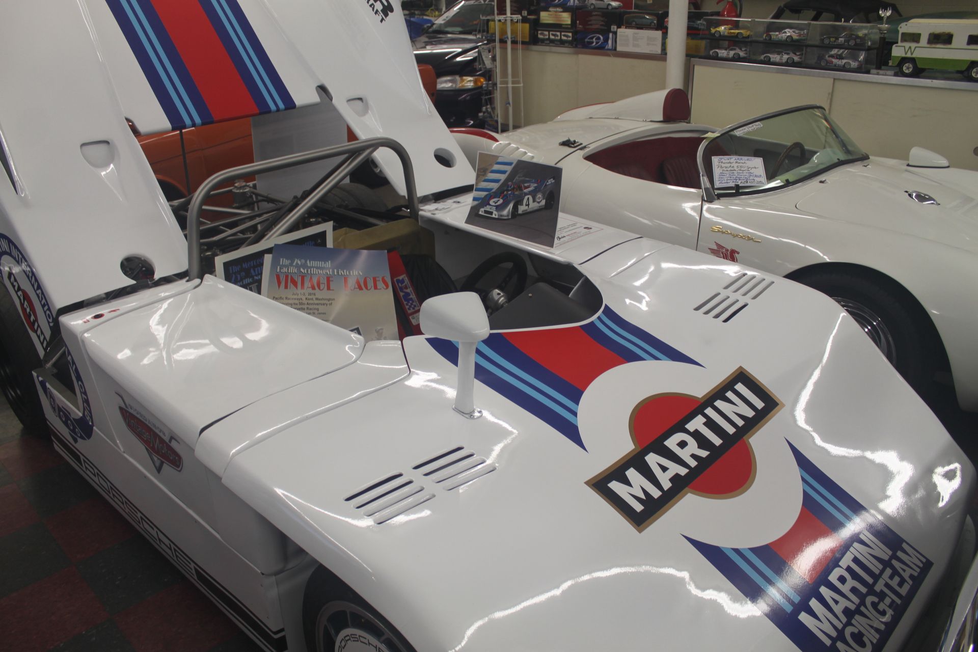 a red and white race car is driving down a track