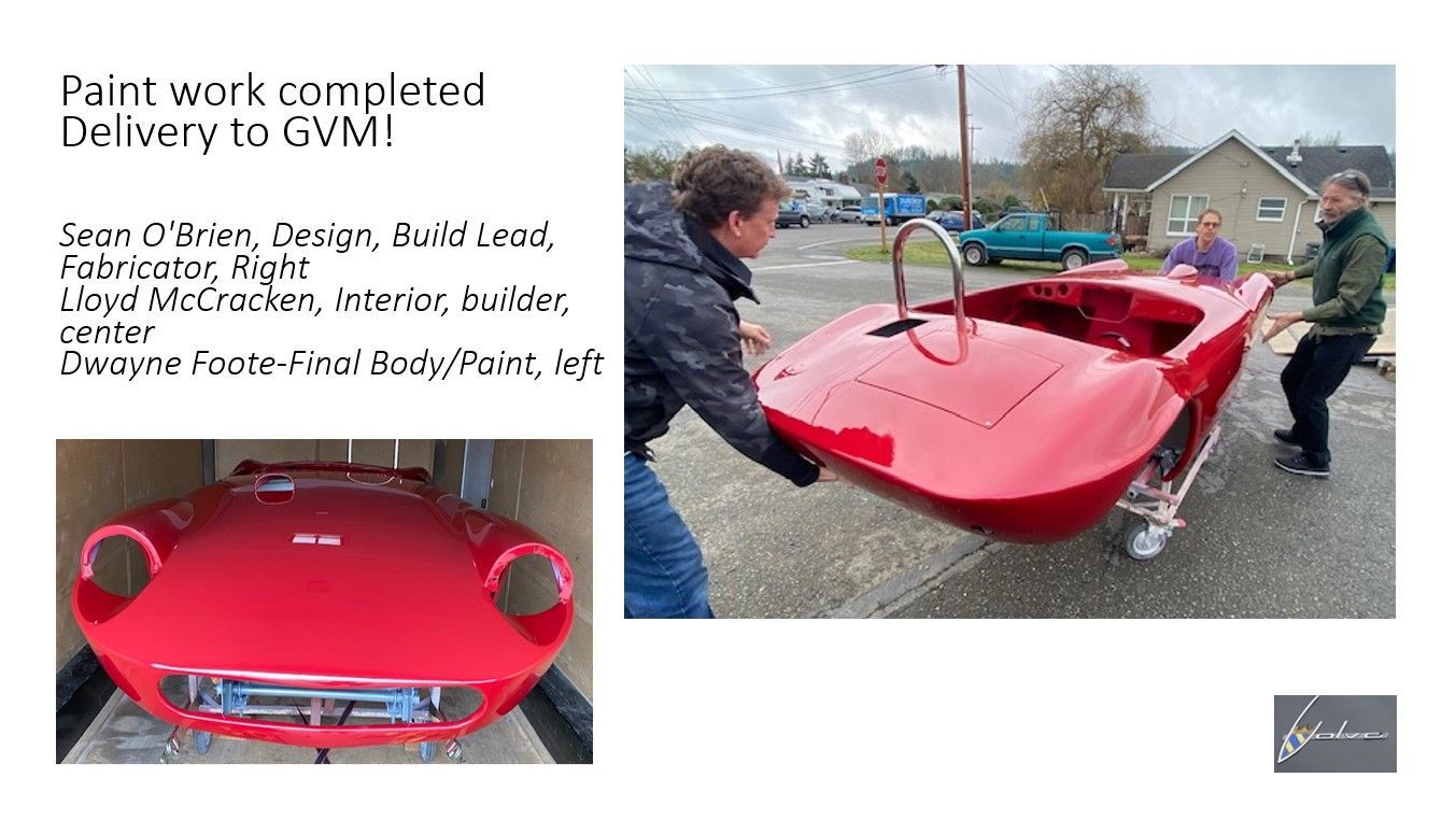 A man is carrying a red car in a box.