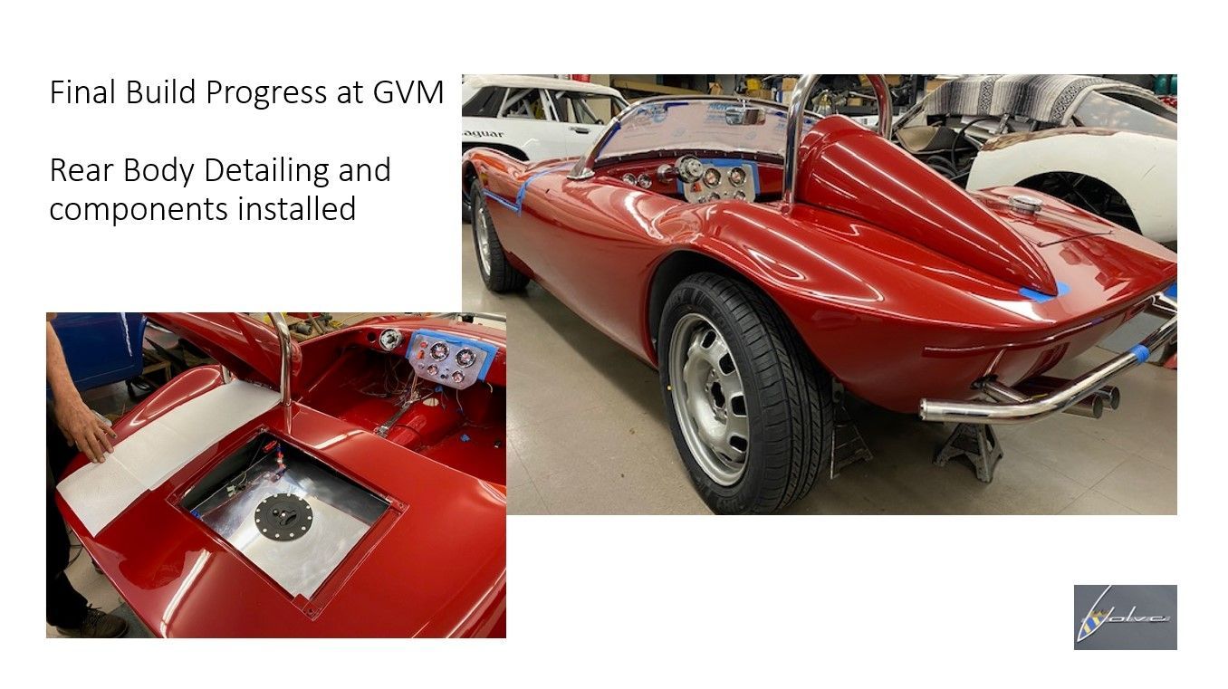 A red sports car is being restored in a garage.