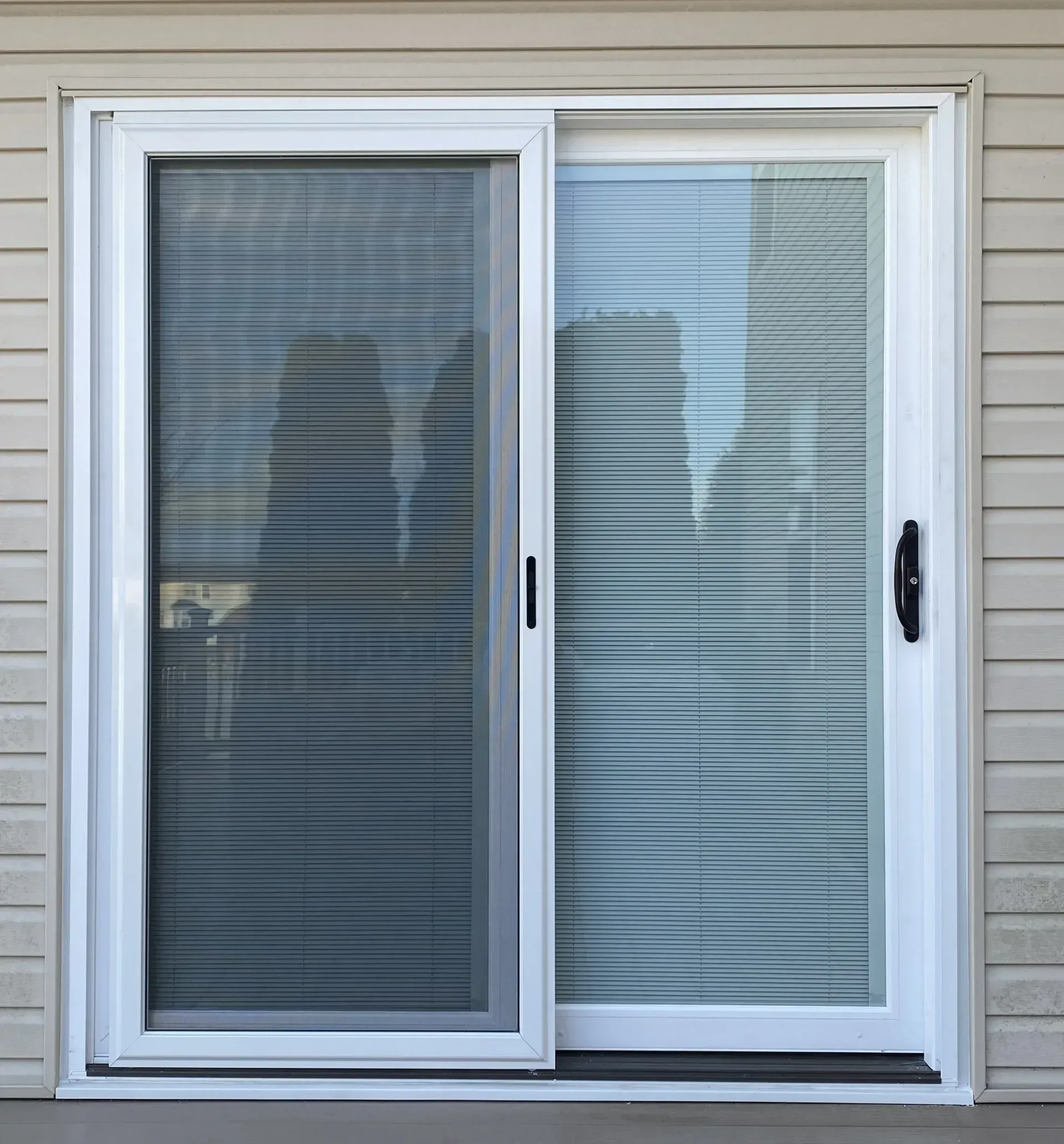 A White Sliding Glass Door is Sitting on the Side of a House | Philadelphia, PA | First Choice Door and Window