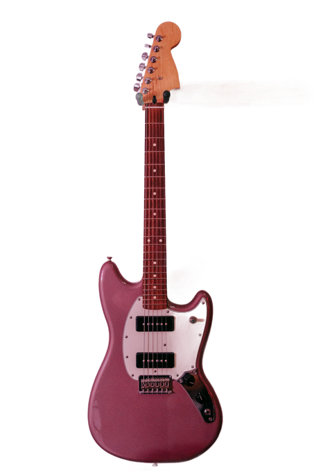 Pink electric guitar on a white background