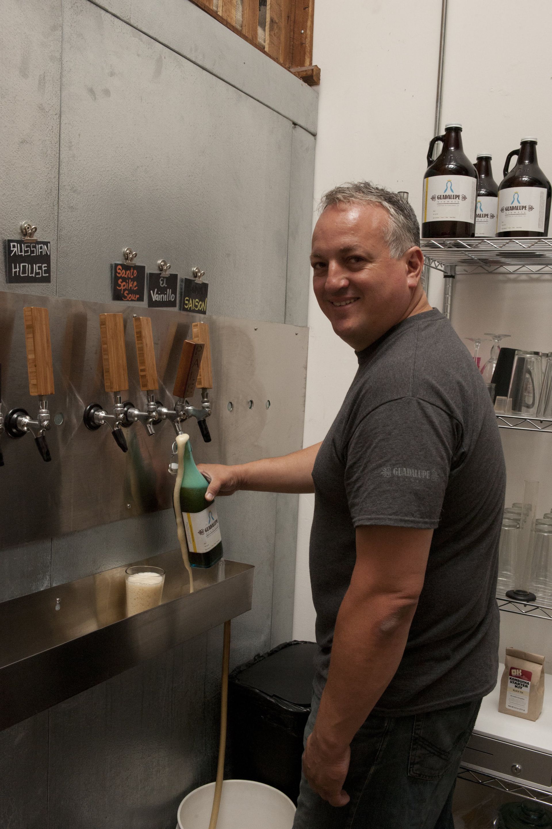 Man filling the glass with beer