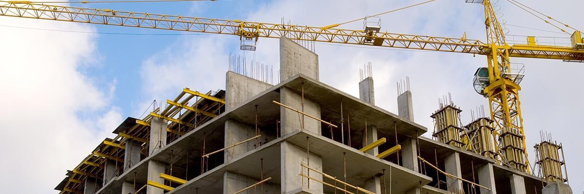 A building is being built with a crane in the background.