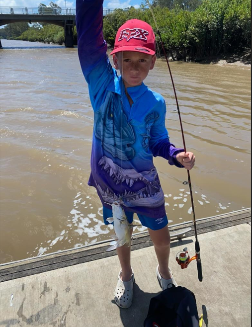 Father laughing and smiling with son - NDIS in Urangan, QLD