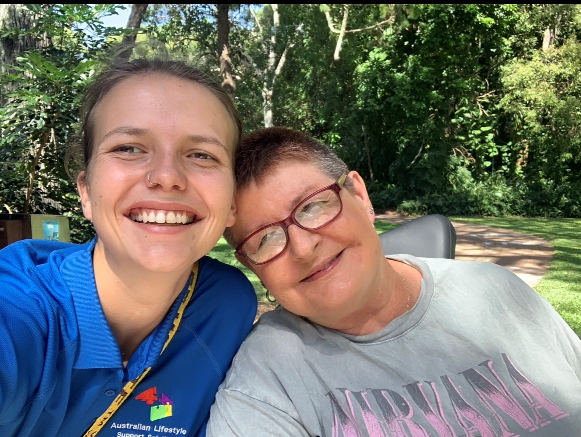 Caregiver woman talking to senior citizen in wheelchair at home - NDIS in Urangan, QLD