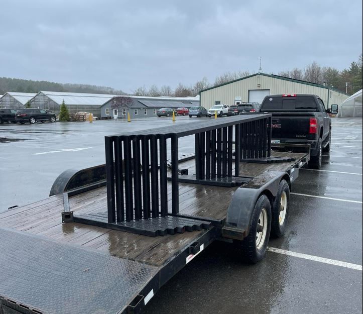 A truck is pulling a trailer in a parking lot.
