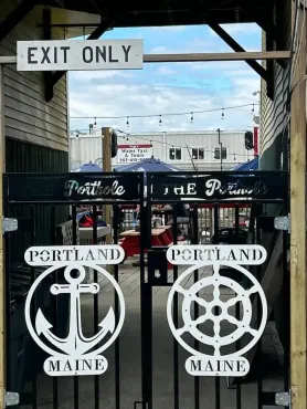 A gate with a sign that says exit only on it.