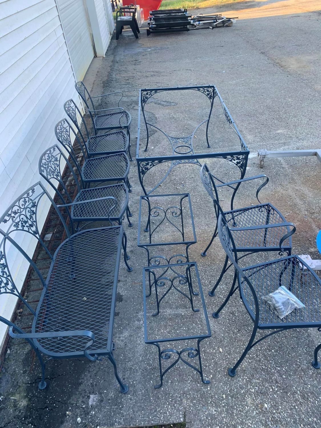 A table and chairs are sitting on the side of a road.