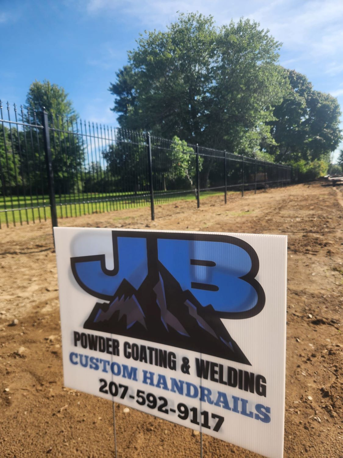 A sign for jb powder coating and welding custom handrails