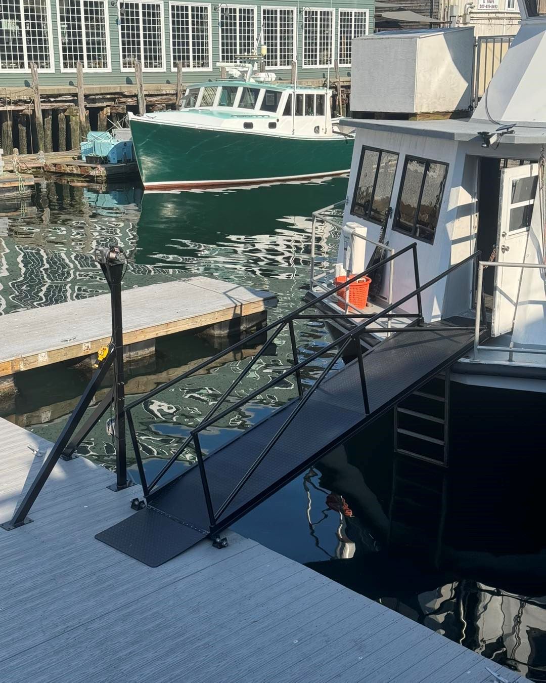 A boat is docked at a dock with a ramp leading to it
