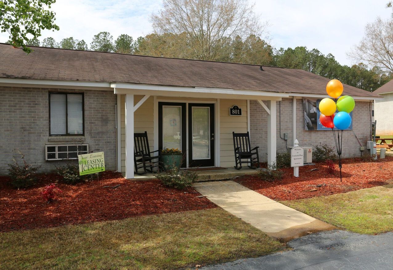 A house with rocking chairs and balloons on the porch