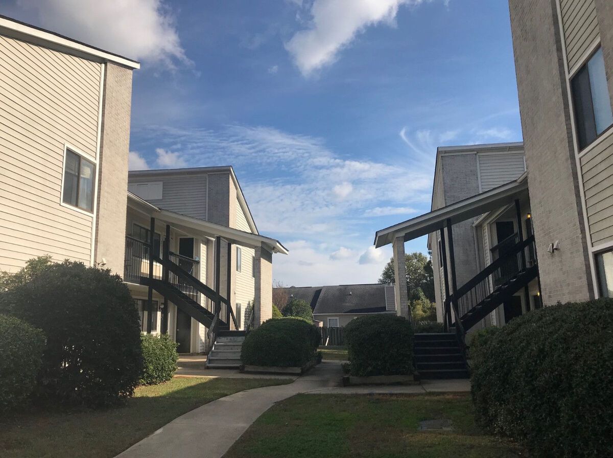 A row of apartment buildings with a blue sky in the background.