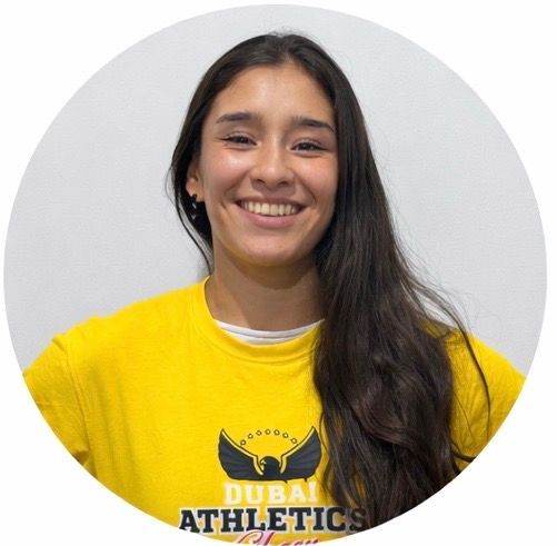 Woman smiling, wearing a yellow 