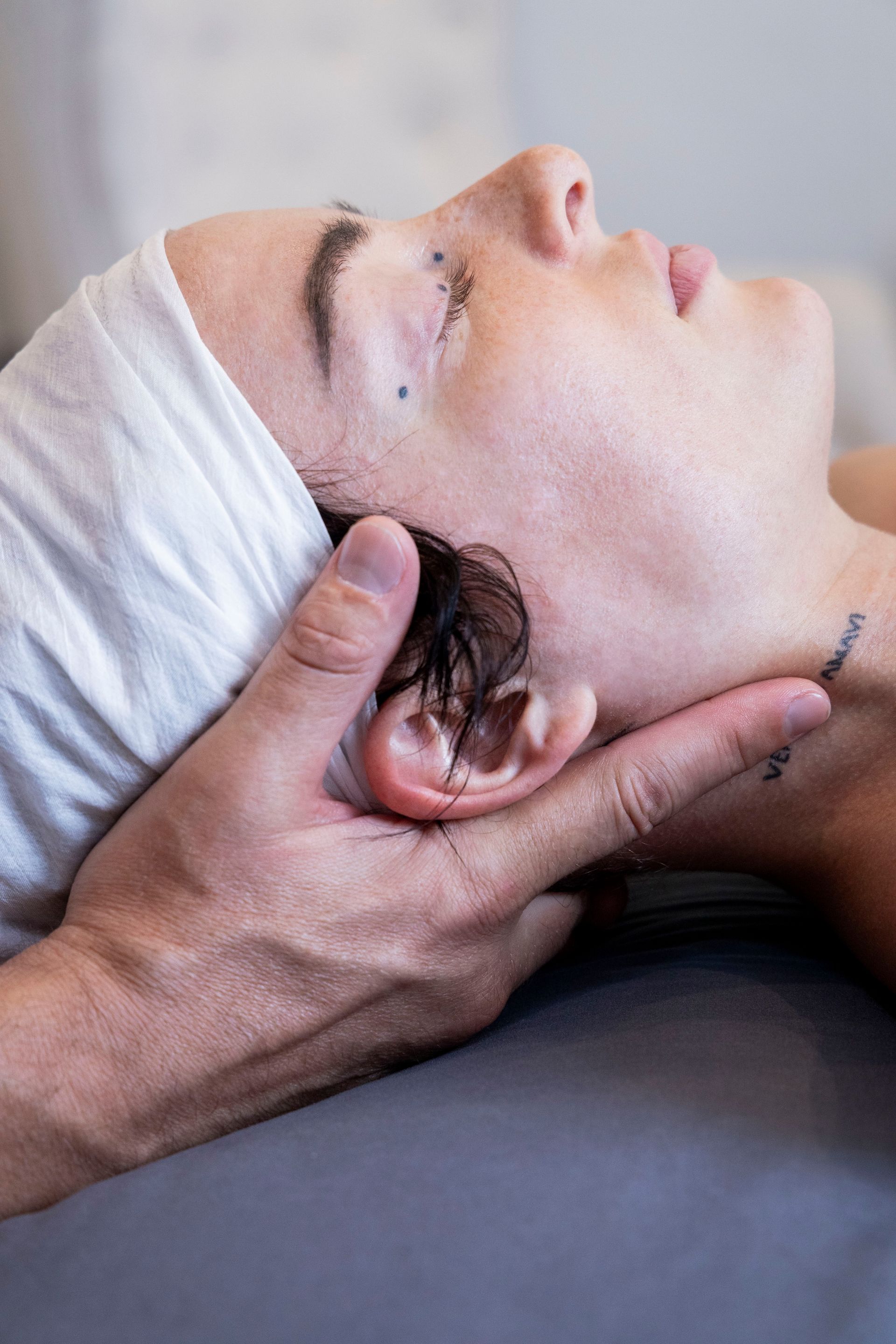 Person receiving cranial sacral therapy.