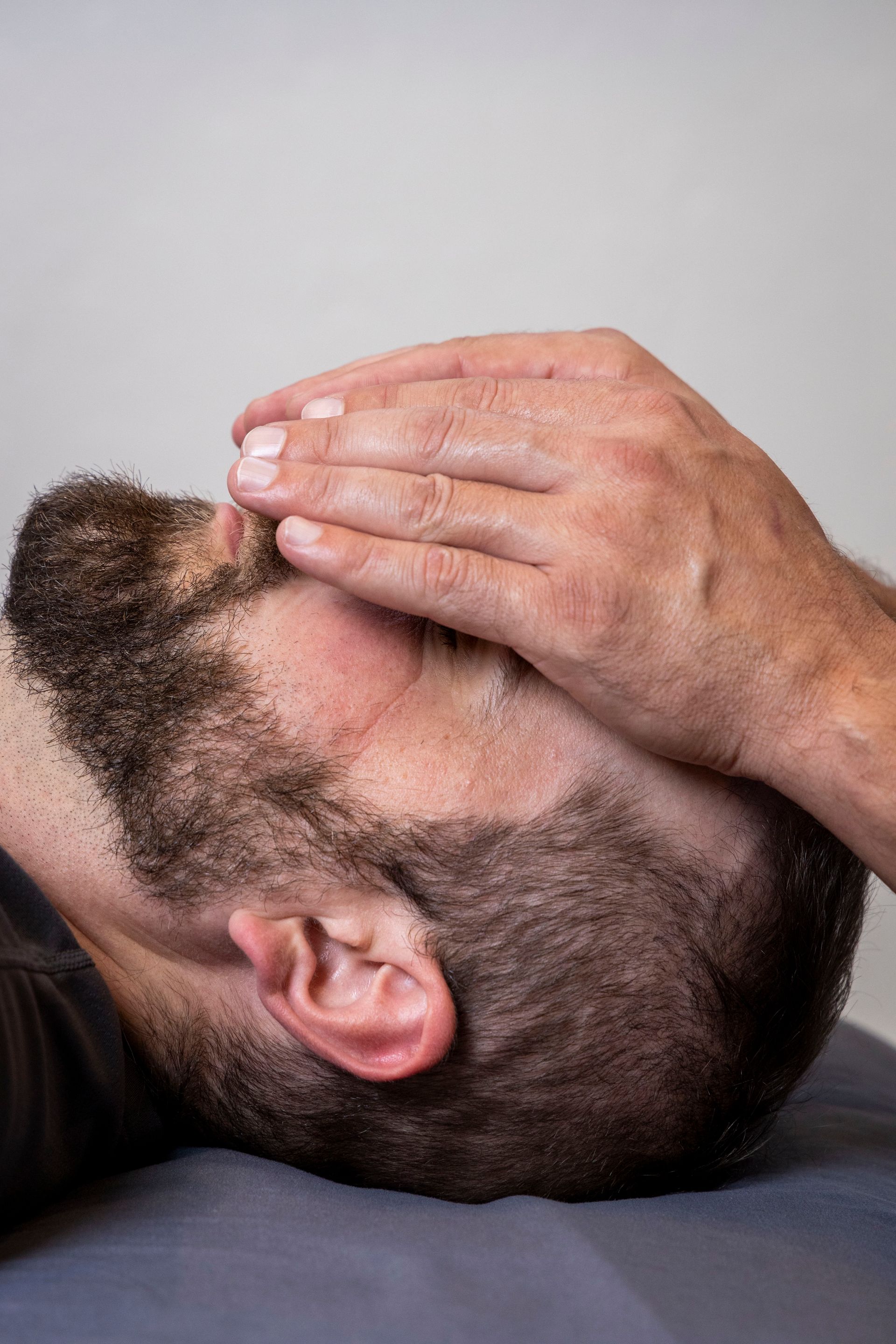 A man receiving Reiki therapy
