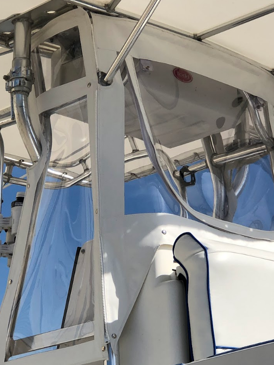 Boat structure with clear plastic and white metal framing.