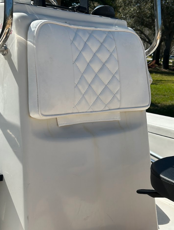 White boat helm with a diamond-stitched backrest cushion.