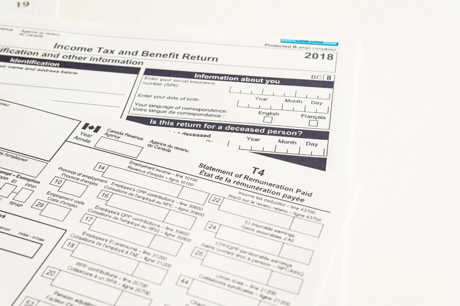A white Income Tax and Benefit Return form from 2018 is laying on a white surface, showing the form's details.