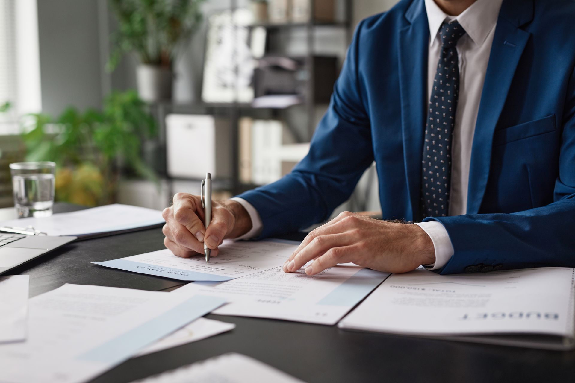 A man is signing a document. A man is signing a document.